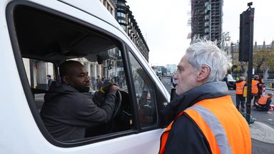 A protester from Insulate Britain speaks to a motorist as they block Great George Street in Parliament Square, central London. Picture date: Thursday November 4, 2021.  